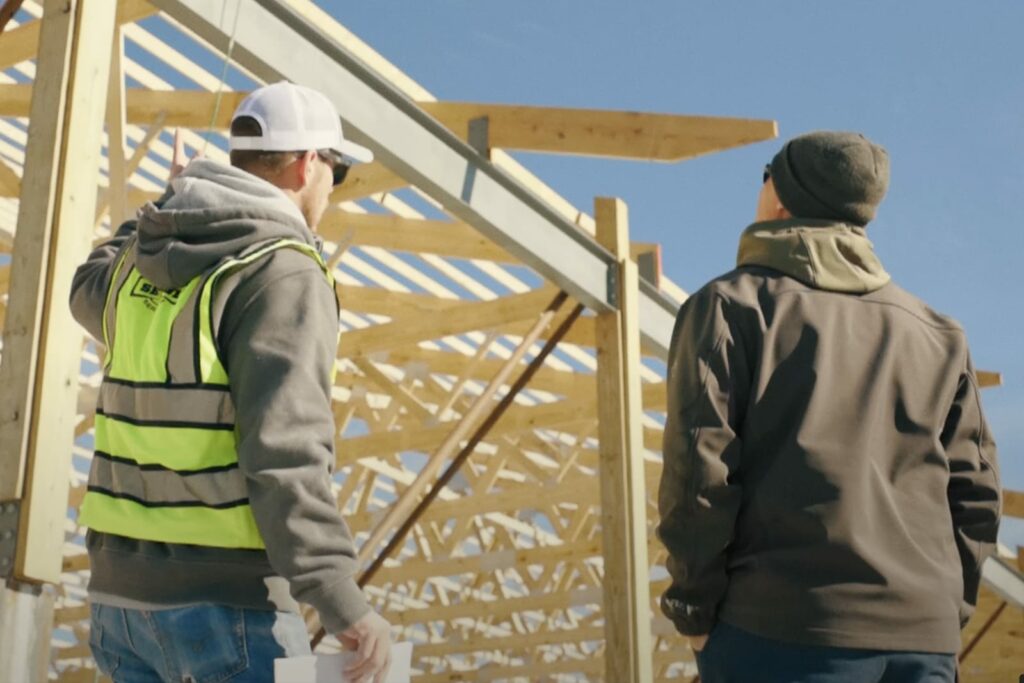 Two Settje Employees evaluate an building structure under construction